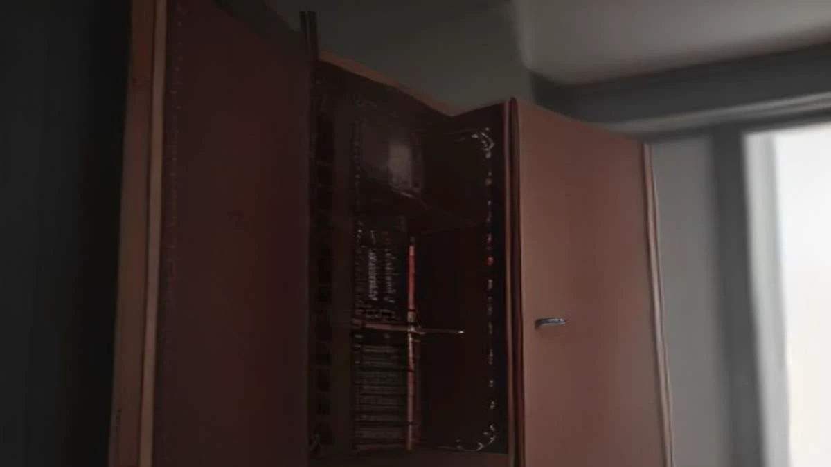 A copper busbar and heavy gauge wiring inside an electrical cabinet, seen from a low angle in soft overcast daylight